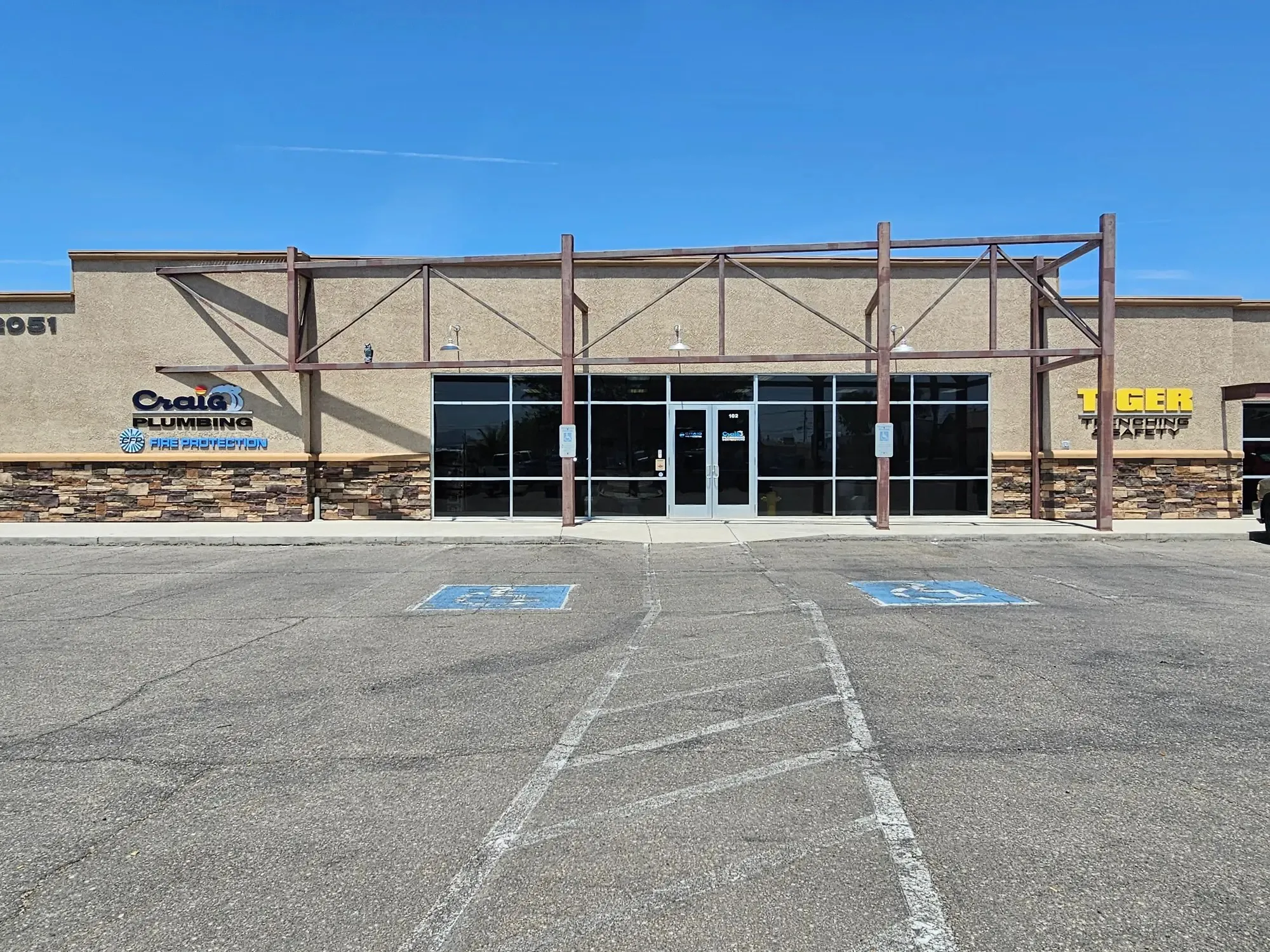 The Craig Plumbing shop, a tan stucco storefront at 2051 Holly Avenue in Lake Havasu City